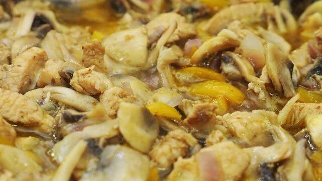 Chicken, onions, and champignons are fried in vegetable oil