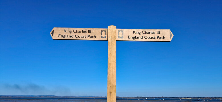 Wooden fingerpost sign for the King Charles III Coastal Path