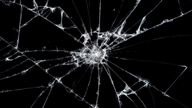 Cracked glass fracture effect on black background. Breaking glass motion graphics.Motion graphics with cracking and breaking glass surfaces. Dynamic cracked screen overlay.