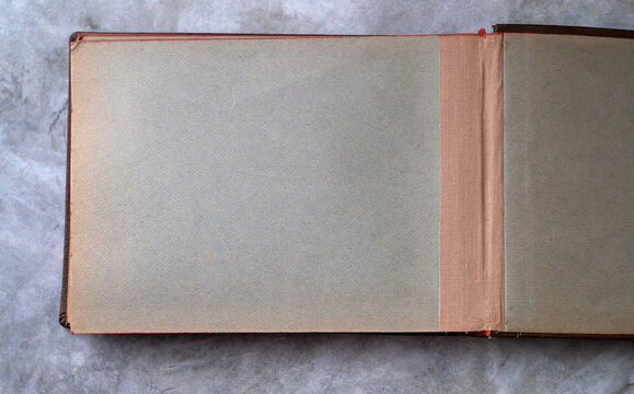 An empty page of an old cardboard photo album.A dark page for text.A sheet of cardboard in the folder for the table of contents.