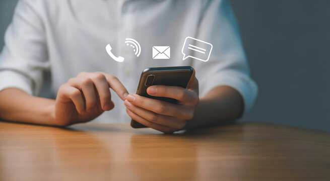Man using smartphone with virtual contact icons including phone, email, and chat for customer support and communication