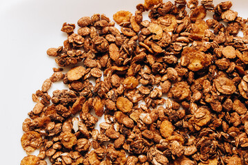 Obraz premium Granola snack in a white bowl made from oats and nuts served on a kitchen table