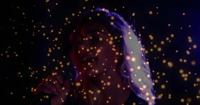 Female singer bringing mic to mouth starting singing for music gold overlay rim lights tracing hair