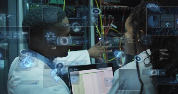 Female tech pointing laptop, male tech touching cables, fixing network with AR overlays responding