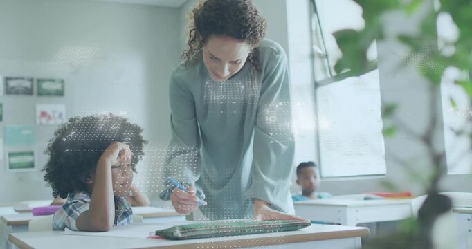 Teacher in class leaning over student, reaching and guiding, teaching writing dot overlay appearing