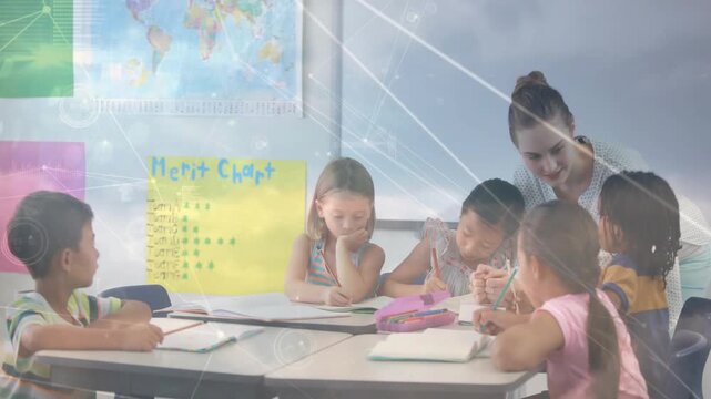 Teacher leaning over table guiding writing, sparking education overlay highlighting notebooks, map