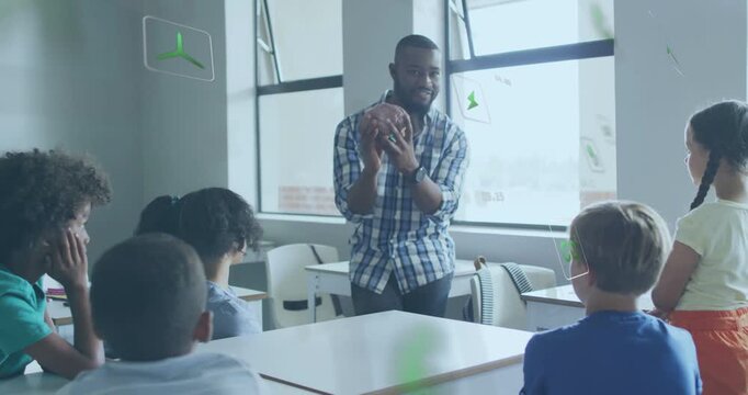 Vertical video: Picking up football, teacher in plaid teaching students in class with green icons