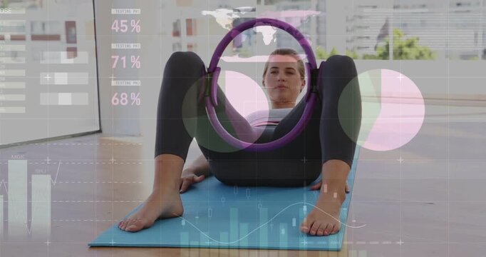 Woman responding to HUD prompt, pressing purple pilates ring on blue mat, engaging core for fitness