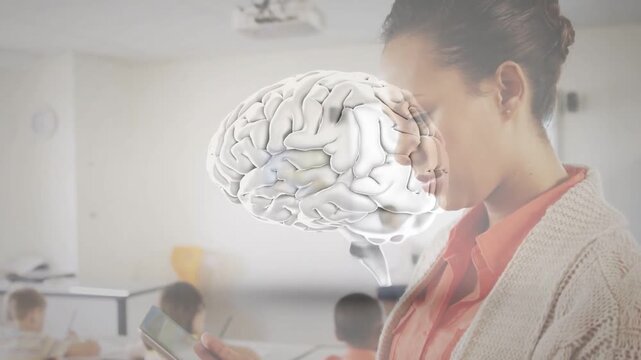 Female teacher tapping tablet classroom, bringing 3D brain overlay aligning with head for lesson