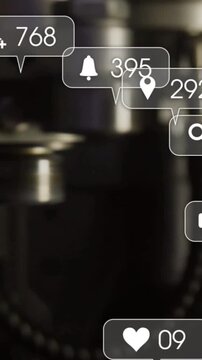 Vertical video: Camera panning factory metal assembly, social hearts growing and showing engagement