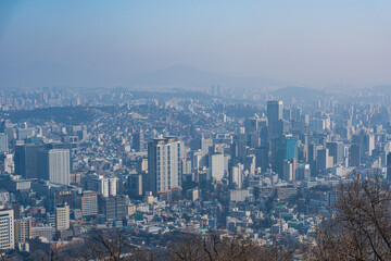 Fototapeta premium Aerial view of Jung-gu district buildings and urban landscape in Seoul, captured from Namsan Mountain.