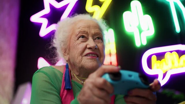 Trendy 80-year-old woman playing video game with joystick, leisure activity