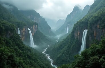 Fototapeta premium Misty mountain valley with multiple tall waterfalls flowing down steep, jungle-covered cliffs into winding river below. Green vegetation covers landscape. Serene nature scene with sense of adventure,