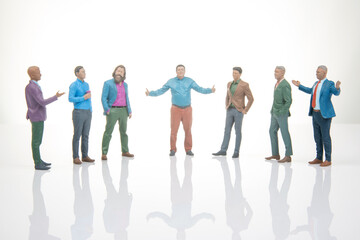 Obraz premium Seven miniature figurines stand in a circle with one figure gesturing while others listen at a white background