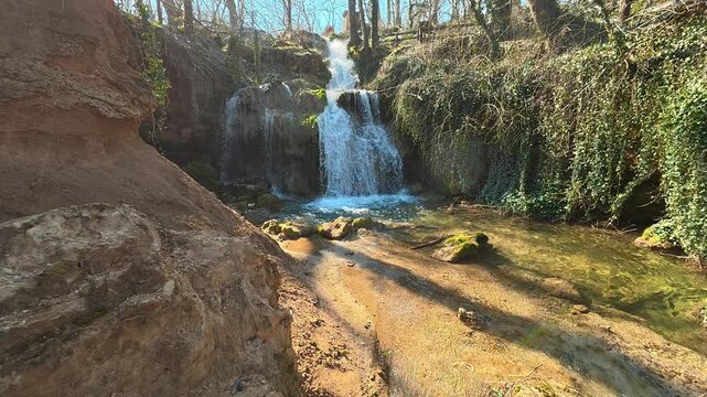 Forest Waterfall With Emerald Pool Camera Tilt Up and Pan Left
