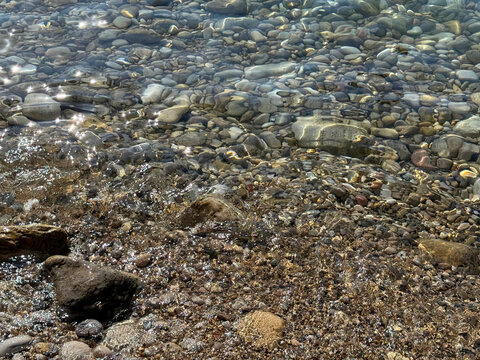 Clear sea and pebbly beach.