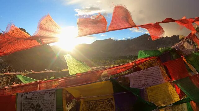 uddhist Prayer Flags Waving in Wind with Himalayan Mountains and Stupas on Sunny Day
