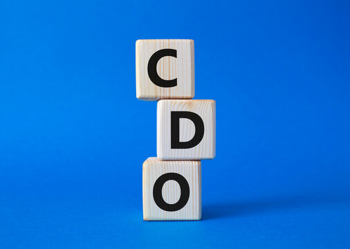 CDO - Collateralized Debt Obligation symbol. Wooden cubes with word CDO. Beautiful blue background. Business and Collateralized Debt Obligation concept. Copy space.