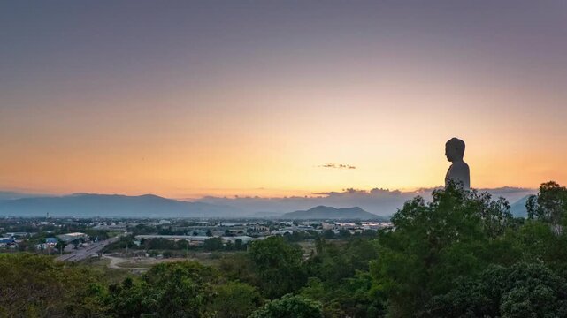 Timelapse of the standing Buddha at Tong Lam Son Temple Lo Son in Nha Trang, Vietnam. Sunset sky transitions into evening 