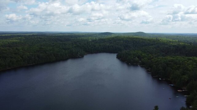 Flying over Buckskin Lake on a late summer afternoon towards the expansive wilderness of crown land located in the Tory Hill area of Highlands East, in southern Ontario, Canada.