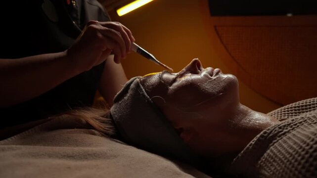 Soothing nighttime spa facial treatment with rejuvenating mask application, relaxing ambiance, and gentle skincare therapy for calm, glowing, refreshed complexion