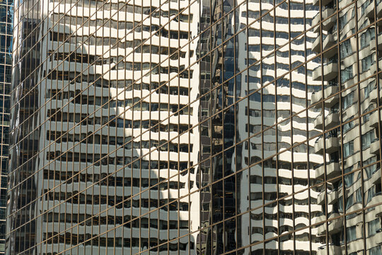 Canada, Alberta, Calgary.  Reflections in the glass of highrise office towers in the financial district.