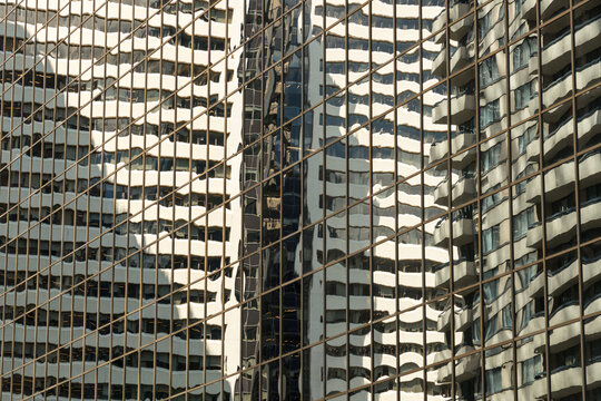Canada, Alberta, Calgary.  Reflections in the glass of highrise office towers in the financial district.