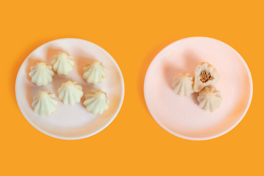 Steamed sweet modak rice dumplings on white plates. Ganesh festival