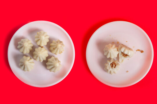 Steamed sweet modak rice dumplings on white plates. Ganesh festival