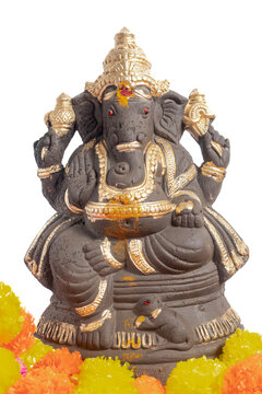 Gold decorated Ganesha idol with marigold flowers, for Ganesha Chaturthi worship