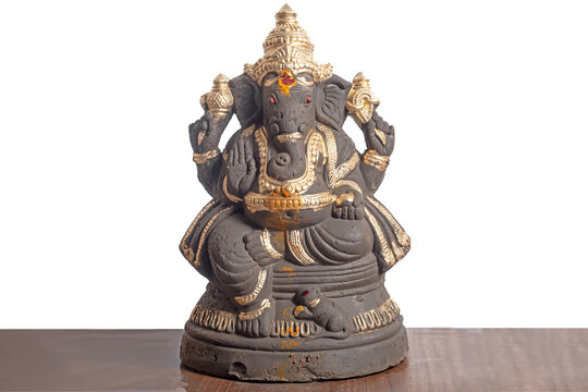 Clay Ganesha idol decorated in gold for Ganesha Chaturthi