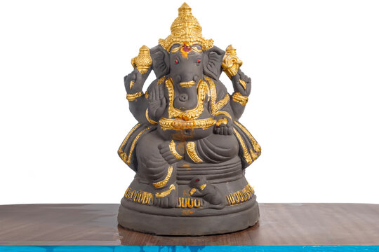Ganesha idol adorned with gold color decoration for Ganesh Chaturthi.
