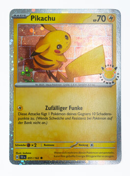 Hamburg, Germany - 06062025: detail shot of the pokemon paper card Pikachu TEF DE Promo from the Pok&eacute;mon Day 2026 with 30th anniversary stamp.