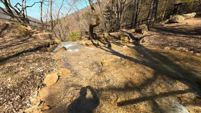 POV Shadow Filming Forest Stream Flowing Toward Waterfall. Ozren Mountain, Sokobanja region. Balkans, Serbia.