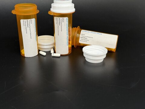 Medication side effects and treatment cycle concept with prescription bottles