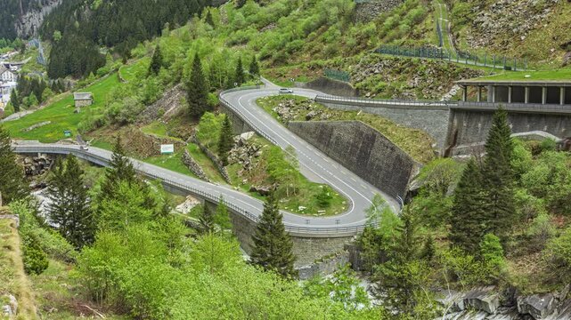 Time lapse, serpentine mountain road. Winding road in mountains. Schoellenen Gorge or Schoellenenschlucht, Canton of Uri, Switzerland.