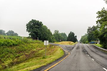 Naklejka premium Rochelle, Virginia in Madison county of Virginia highway road with cars in summer by farm agricultural field in scenic rural countryside