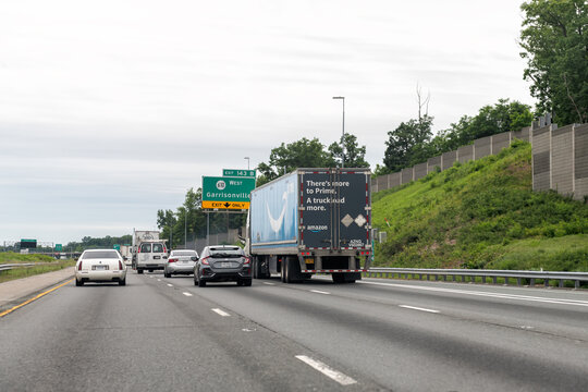 Garrisonville, USA - May 27, 2025: Amazon prime truck shipping delivery vehicle on Virginia highway road with blue arrow logo driving