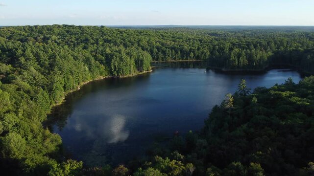 Aerial over Lower Buckskin Lake on a summer afternoon. Expansive wilderness of crown land in Tory Hill, Halliburton Highlands East, Ontario, Canada. Tilting down while moving forward.