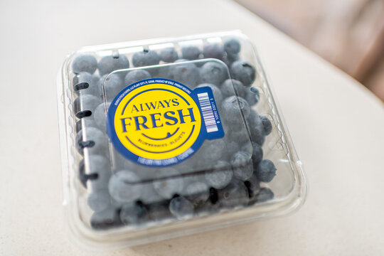 Roseland, USA - February 13, 2025: Storebought Aldi blue blueberry Always fresh berries plastic container with sign label box macro closeup from Chile