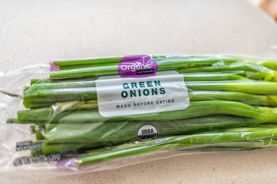 Roseland, USA - March 4, 2025: USDA organic marketside green onions Walmart brand of herb vegetable in plastic bag unwashed