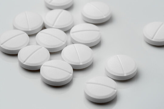 multiple white acetaminophen tablets paracetamol for pain relief and medication dosage concept