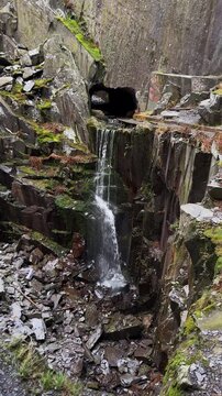 Secret Waterfall from Slate Cavern Tunnel Entrance, Dinorwig Quarry, Dinorwic, Eryri Snowdonia National Park, North Wales, United Kingdom