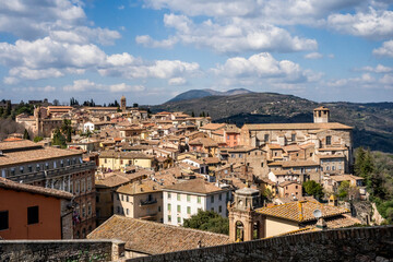 Naklejka premium Panoramic view from the Porta Sole viewpoint over Palazzo Gallenga Stuart (University for Foreigners), the medieval Borgo Sant'Angelo and the surrounding Umbrian hills, Perugia, Umbria, Italy.