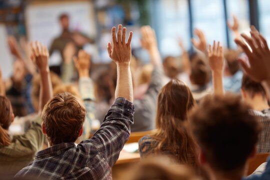 Engaged students raising hands in a classroom setting.