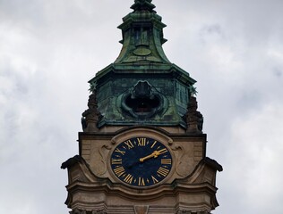 Historic tower under cloudy sky. Architectural monument with baroque elements and weathered finish © Vladimir