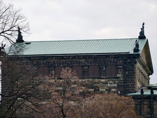 Old stone facade under grey sky. Historic architecture set in tranquil winter urban environment © Vladimir