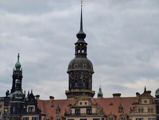 Obraz premium Historic cityscape vista. Expansive view of historic structures and castlelike silhouette under cloudy skies