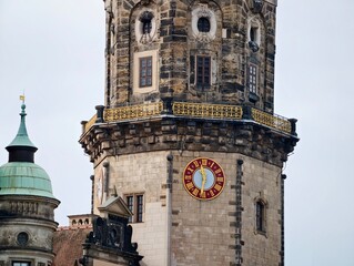 Old stone clock tower under cloudy sky. Weathered masonry tower with decorative cornices and clock face © Vladimir
