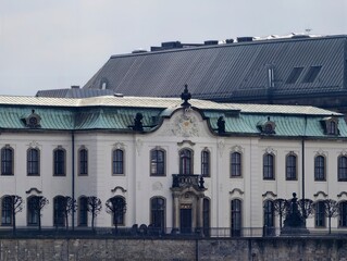 Timeless classical edifice situated by peaceful river with overcast skies and subdued tones © Vladimir
